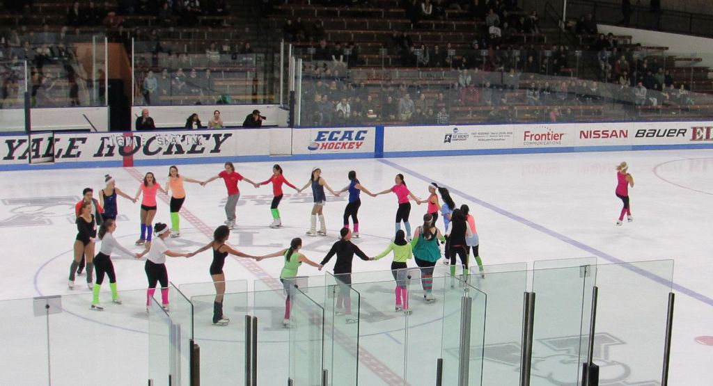 The Yale Figure Skating club skates in a circle together.